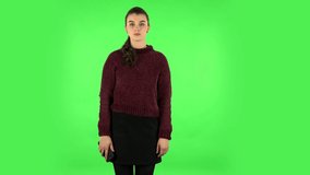 Girl talking for video chat using mobile phone on green screen