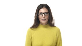 Slow-motion fascinated and impressed, excited brunette woman in glasses, open mouth astonished, gasping amused, touch cheeks and stare camera speechless, standing white background