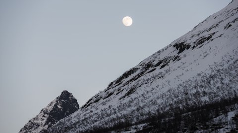 Moon moving over the mountain
