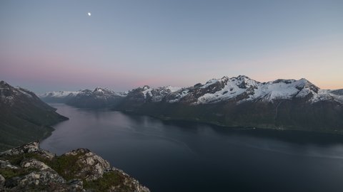 Moon moving over the fjord