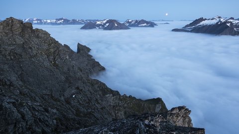 Inversion with moonset over the norwegian fjord