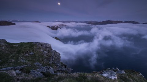 Moon with inversion flowing over the coastline