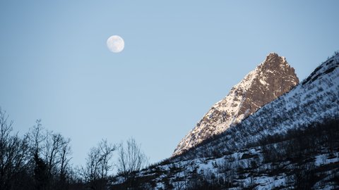 Moon moving over the mountain