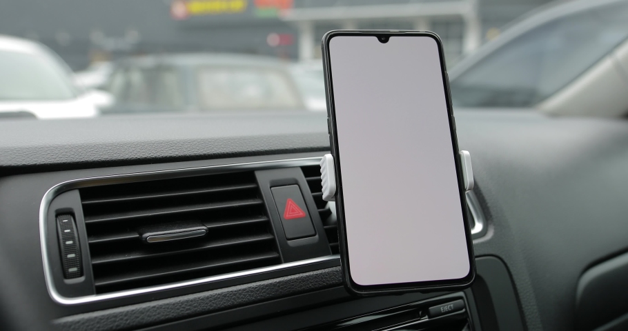 White empty screen of smartphone in a car, mockup for your site Royalty-Free Stock Footage #1044741964
