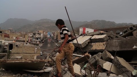 Taiz  Yemen - 09 Feb 2017 : A child from Taiz City Walk on the ruins of his ruined home because of the war on the city-Yemen.