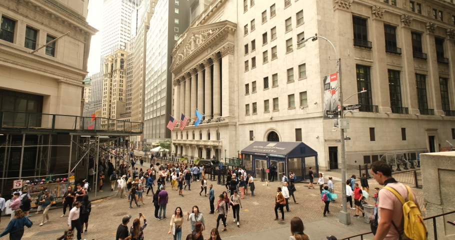 Manhattan, New York - September 18, 2019: People sit on the steps of Federal Hall by the New York Stock Exchange building in the financial district on Wall Street in lower Manhattan New York USA