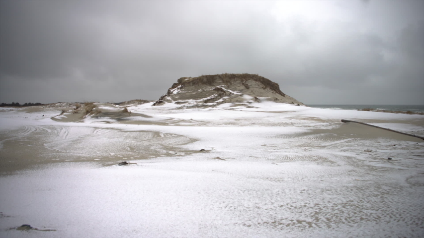 Snow coverd beach during a cold winter day on the coast.