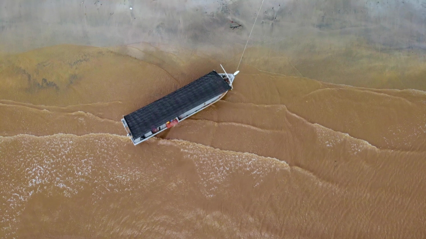 aerial footage of a fishing boat fishing by the sea