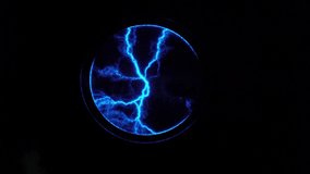 Tesla Plasma Ball Coil. 4k video. Violet plasma ball of lightning. Experiments with electricity. Flash of lightning. Electricity is cracking. Abstract background with electric arcs. Museum