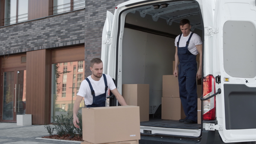 Professional Workers on Stacking Boxes for Transportation. Concept of Trade Transit on Truck or Carriage on Van. Lifestyle of Caucasian Delivery Men. Job of Piling Carton Packages at Lorry for Convey Royalty-Free Stock Footage #1044773491