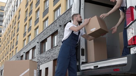 Professional Workers on Piling Boxes for Transportation. Concept of Trade Transit on Truck or Carriage on Van. Lifestyle of Reliable Deliveryman. Job of Sorting Carton Packages at Lorry for Delivery