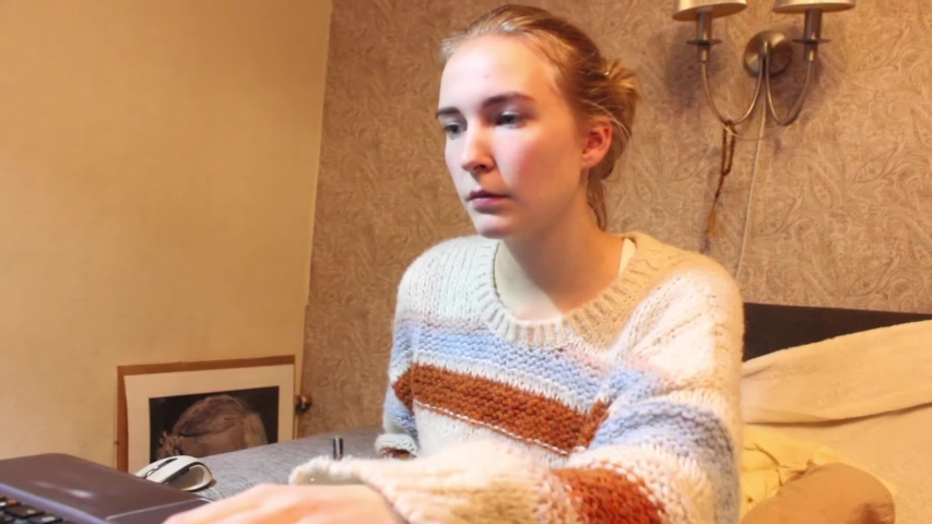 Young girl is working in front of her laptop at home