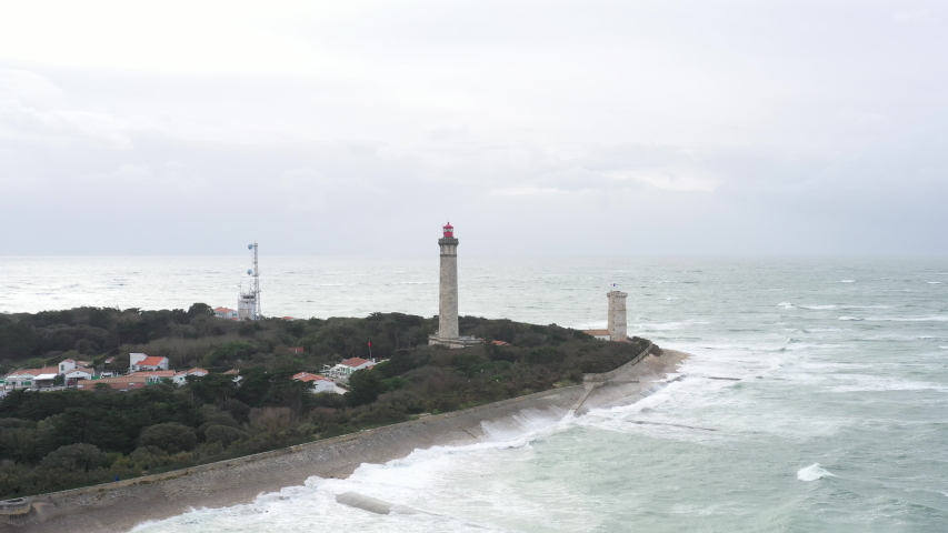 Aerial shot of the lighthouse "phare des baleines" in France during a cloudy day. Bad weather day, shot located in the Île de Ré.