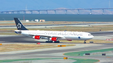 SAN FRANCISCO, CA - 2020: SAS Scandinavian Airbus A340 Jet Airliner with Star Alliance Livery Arriving in Heat Waves at San Francisco SFO International Airport Turning from Runway and Taxiing