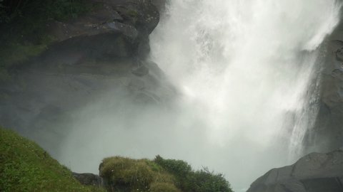 Closeup View of Krimml Waterfall with powerful stream of water falling down with a splash