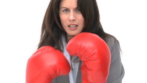 Serious businesswoman with boxing gloves