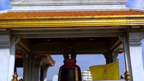 BANGKOK, THAILAND, December 31 2019: Big  bell surrounded with small bells in front of the Buddhist temple in Bangkok, Thailand.