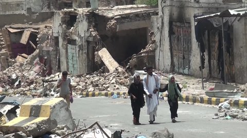  
Taiz  Yemen - 04 Aug 2015 : People passed by the buildings that were destroyed during the war between the Popular Resistance and Al-Houthi militia in Taiz City