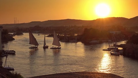 Beautiful view on felucca boats on Nile river in Aswan at sunset, Egypt, 4k