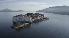 Isola Bella and Stresa town aerial panoramic view. Isola Bella is one of the Borromean Islands of Lago Maggiore in north Italy - an aerial view - D-LOG UNGRADED VIDEO