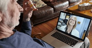 Female doctor saying goodbye to an attractive senior man holding a prescription bottle during a telemedicine video chat on a laptop computer