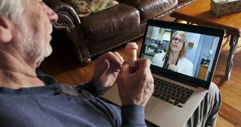 Elderly man talking to a woman doctor, nurse, physicians assistant or health care provider via telemedicine about his medication on a laptop computer