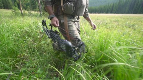 Hunter Hiker in Colorado Stalks through Tall Grass