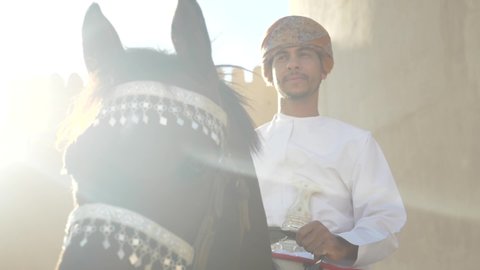 Nizwa, Aldaklia/Oman - November 13, 2019 : Activities and Celebration for the National Day of Sultanate Oman .Omani man ride horse celebrate for the Oman's National Day .
