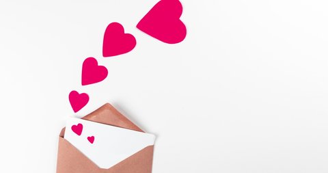 stop motion animation with craft paper envelope and red flying hearts on white background, love, valentines day and wedding greeting concept