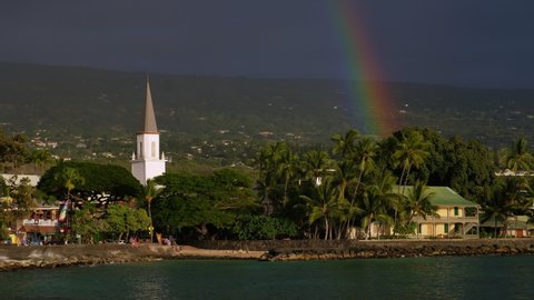 City of Kailua Kona at sunny sunset with rainbow in the sky. Hawaii