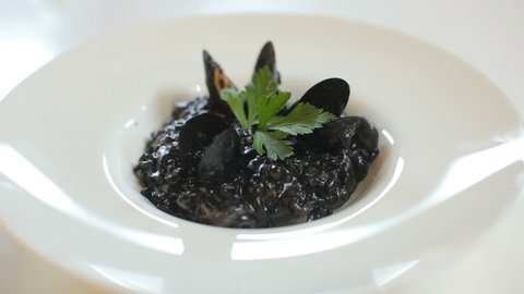 risotto with cuttlefish ink and mussels macro food slide shot