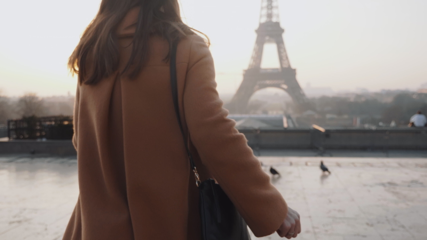 Rear view happy tourist woman running to misty sunrise Eiffel Tower view in Paris on romantic vacation trip slow motion. Royalty-Free Stock Footage #1044844519
