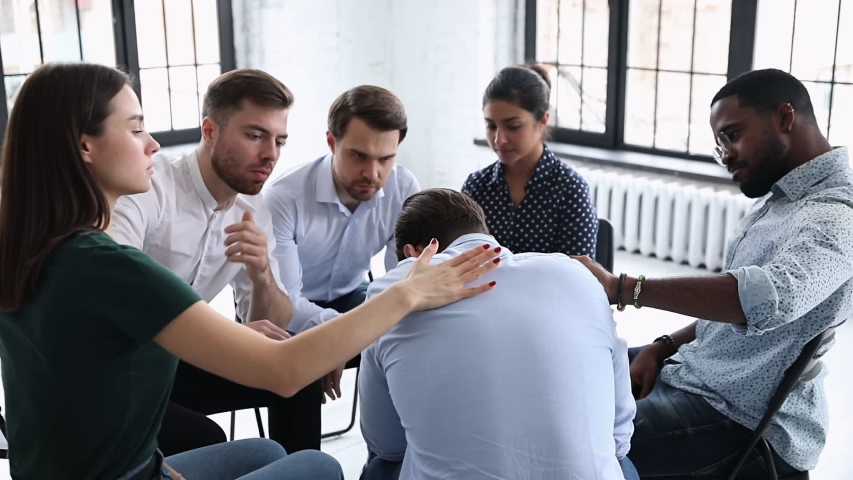 Upset man get psychological support from diverse friends counselor helping at group therapy, male patient feel pain depression share problem addiction during counseling meeting rehab session concept Royalty-Free Stock Footage #1044846352