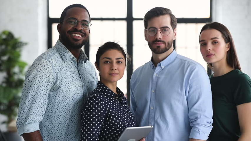 Smiling professional diverse corporate office business team members group look at camera, four happy proud confident multiracial leaders employees staff diverse people group stand together, portrait Royalty-Free Stock Footage #1044846442