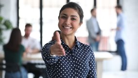 Smiling confident young professional indian ethnic business woman hr employer looking at camera extending hand for handshake offer collaboration in office, introduction concept, portrait, slow motion - Powered by Shutterstock - Get 15% off with code: PIKWIZARD15