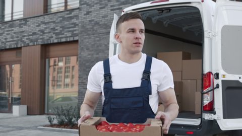 Transportation of Food on Truck. Order of Foodstuffs from Production Warehouse for Sale. Young Worker Carries Boxes of Tomatoes for Provider. Concept of Transfer Company or Carriage on Van or Lorry