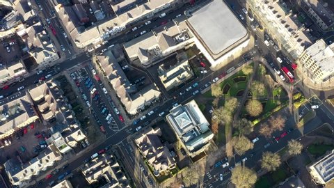Aerial footage of the town centre of Harrogate in the UK a town in North Yorkshire, showing buildings and businesses in the town centre along with roads and paths and the Harrogate Train Station