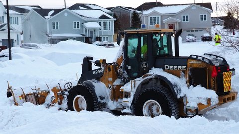 ST. JOHN'S, NEWFOUNDLAND AND LABRADOR, CANADA – JANUARY 18, 2020. A snowplow clearing a city street after a major blizzard, taken on January 18, 2020, in St. John's.