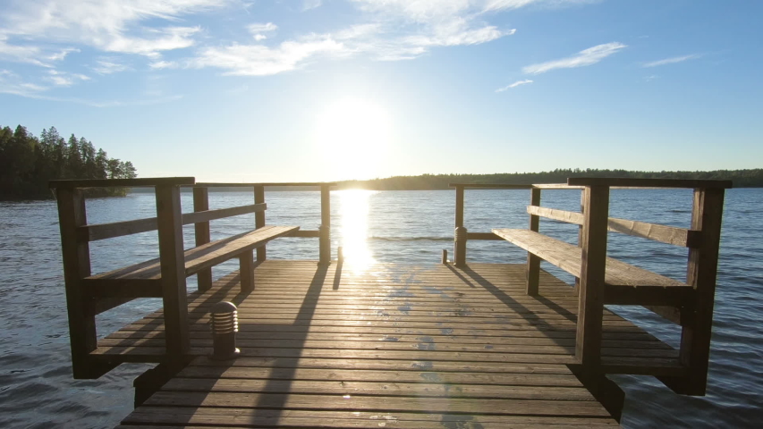 couple running on a wooden pier and jumping into the lake after the sauna in summer white night in Finland. Royalty-Free Stock Footage #1044871108