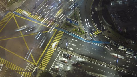 Time lapse of night scene, aerial view of busy junction in Kuala Lumpur, Malaysia. Zoom out