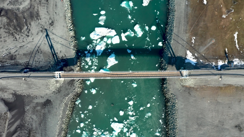 Aerial view of the bridge, glacial lagoon and icebergs. Iceland in early spring