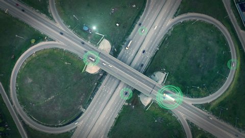 GPS navigation and autonomous driverless transportation concept. Aerial view of transport junction with cars and trucks driving with digital green circles, future global technology on roads