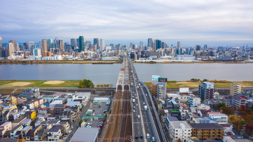 Aerial view Hyper lapse 4k Video of car on highway and Building in Osaka city, Japan.