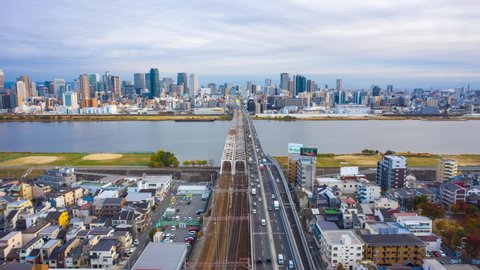 Aerial view Hyper lapse 4k Video of car on highway and Building in Osaka city, Japan.