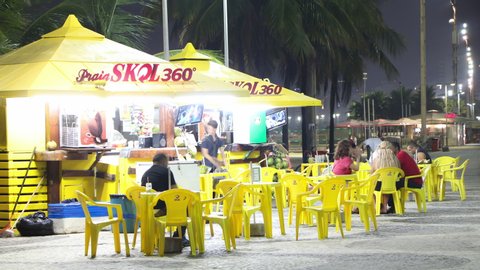 Rio de Janeiro, Brazil - January 18, 2020: Night Timelapse of street bar next to Copacabana beach with people chatting and partying