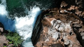 Baikal national nature reserve. Russia. Top down view of the waterfall. Video shot from the air of the fast current of the river.