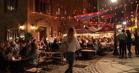 Manhattan, New York - September 20, 2019: People drink and eat by the restaurants and outdoor taverns on historic Stone Street in lower Manhattan in New York City USA.
