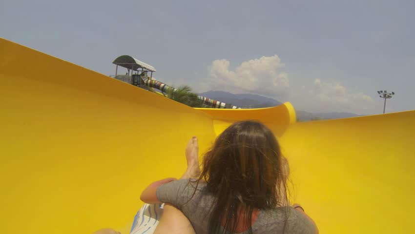 POV Fun with girl on the water slide in aqua park