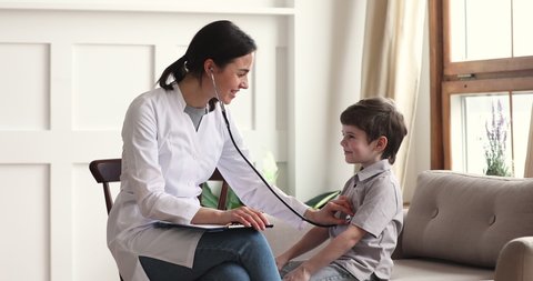 Young female doctor pediatrician nurse wear white coat listening heartbeat exam cute little patient child boy using stethoscope on pediatric checkup appointment, children medical healthcare concept