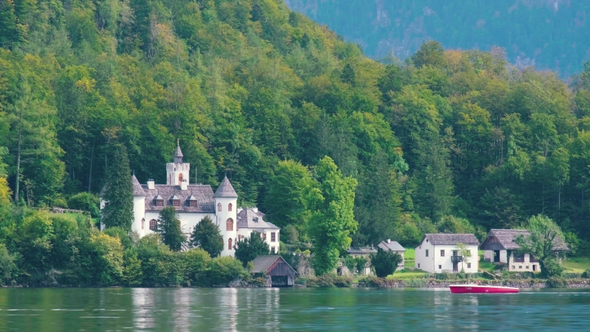 A boat pass though Schloss Grub near by the Hallstatter See in Austria.